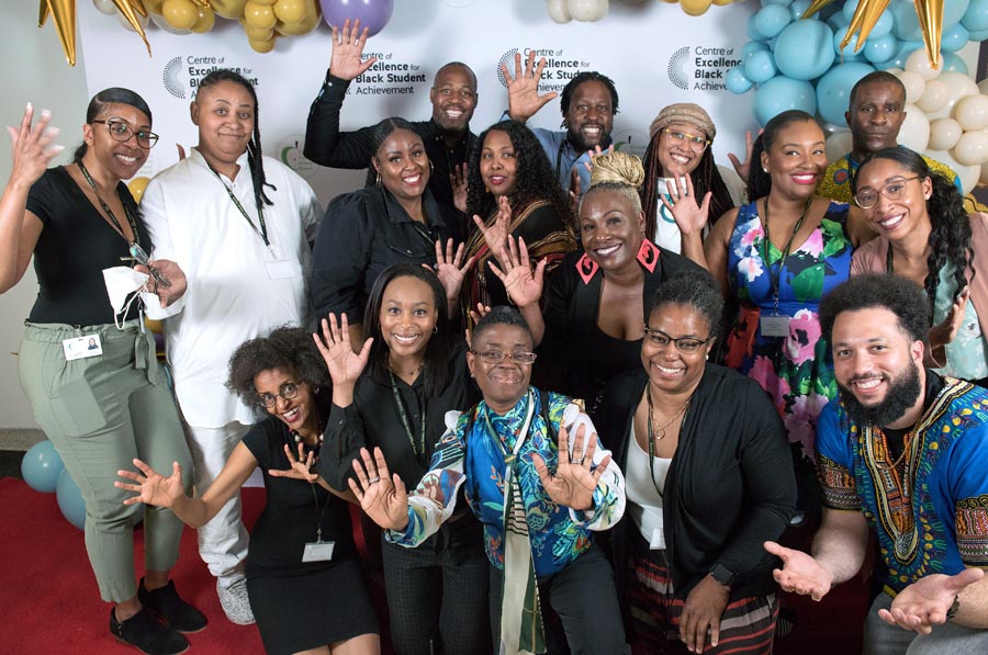 Group photo of the team at the Centre of Excellence for Black Student Achievement waving hello. Open Gallery